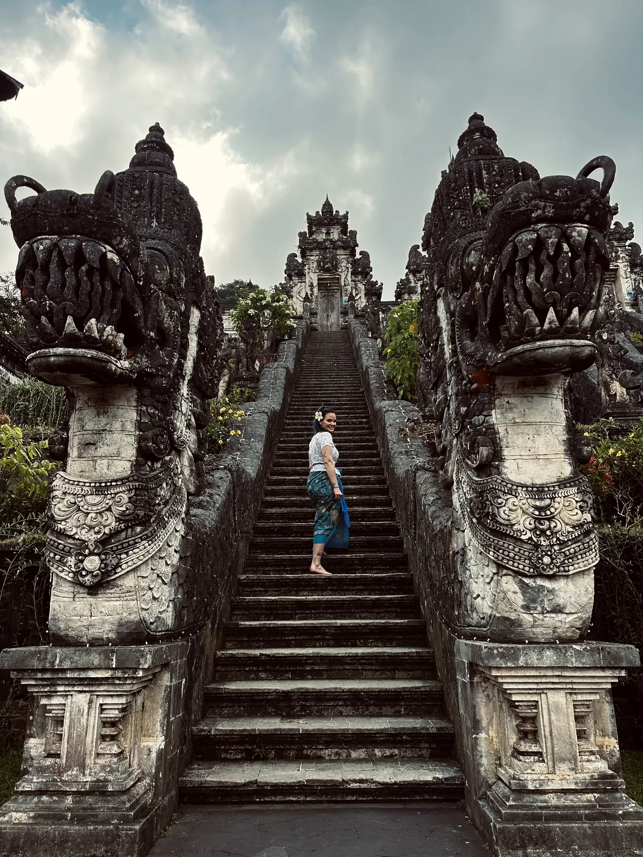 Stone dragon guardians flanking the long staircase at Lempuyang temple
