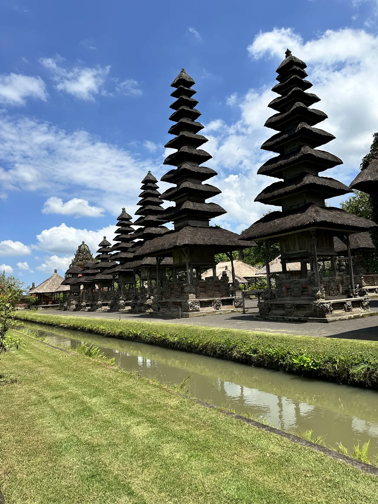 Black-thatched meru towers of a Balinese temple under a blue sky